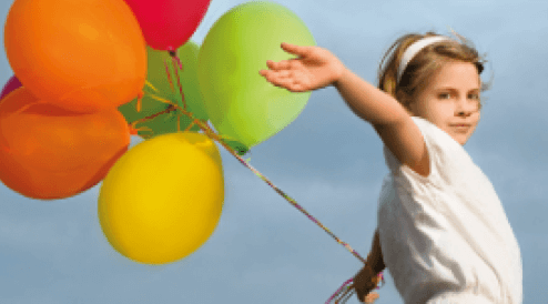 A girl holding a bunch of balloons