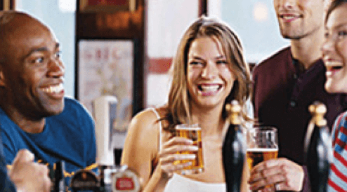 People sitting together smiling and holding drinks