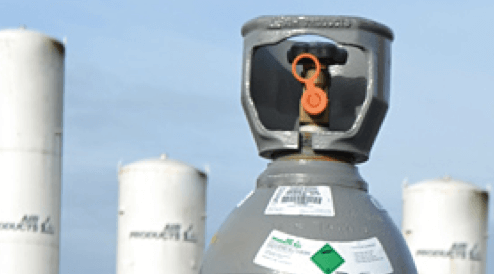 A gas bottle placed in front of industrial buildings